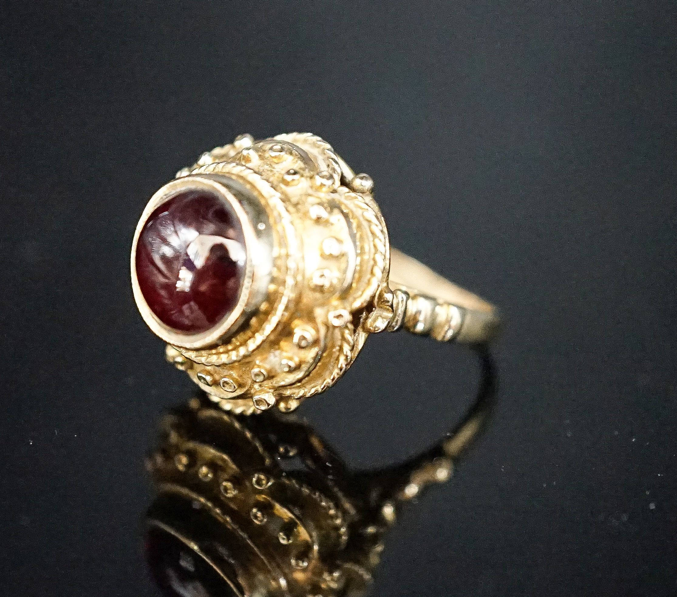 A 1960's Victorian style 9ct gold and cabochon garnet set dress ring, size I, gross 7.2 grams.